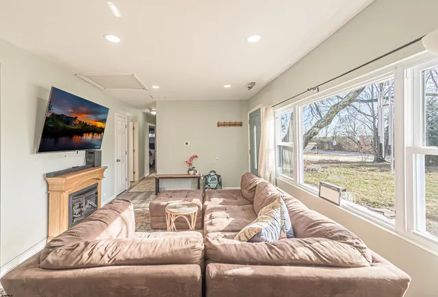 a living room with fireplace furniture and a flat screen tv
