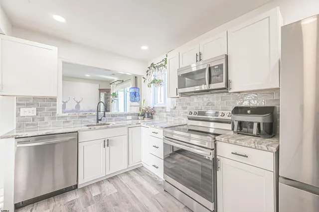 a kitchen with a sink stove and cabinets