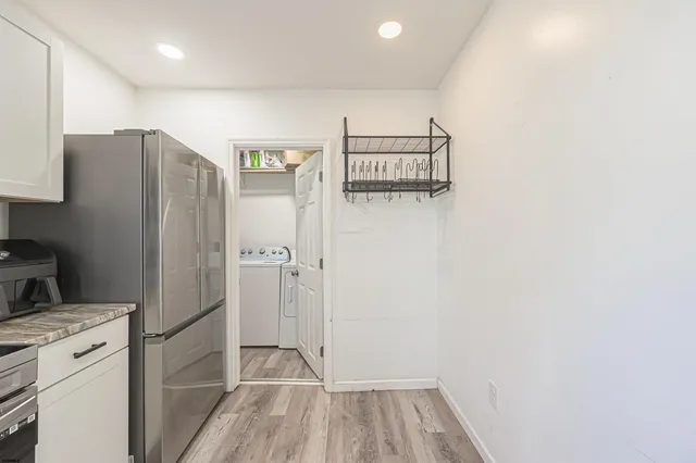 a kitchen with kitchen island a sink stainless steel appliances and cabinets