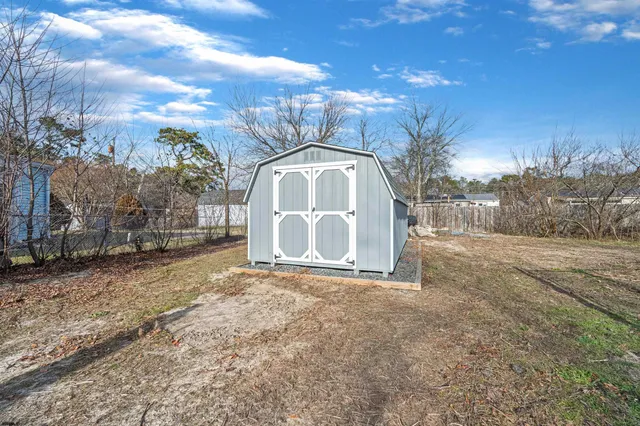 a view of a yard with large trees