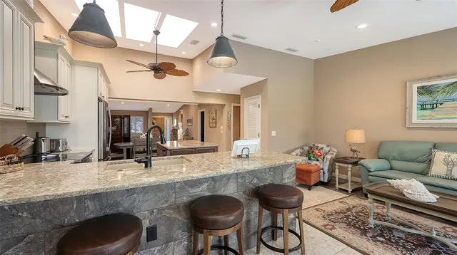 a kitchen with stainless steel appliances granite countertop a sink and a stove