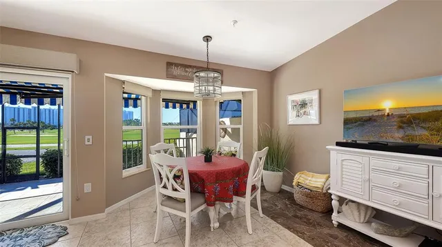 a dining room with furniture a chandelier and window