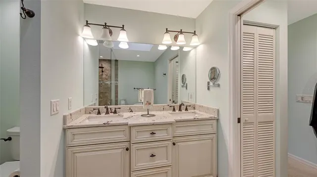 a bathroom with a sink vanity and a mirror