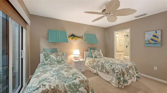 a bedroom with two beds and a chandelier