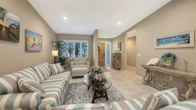 a living room with furniture ceiling fan and a rug