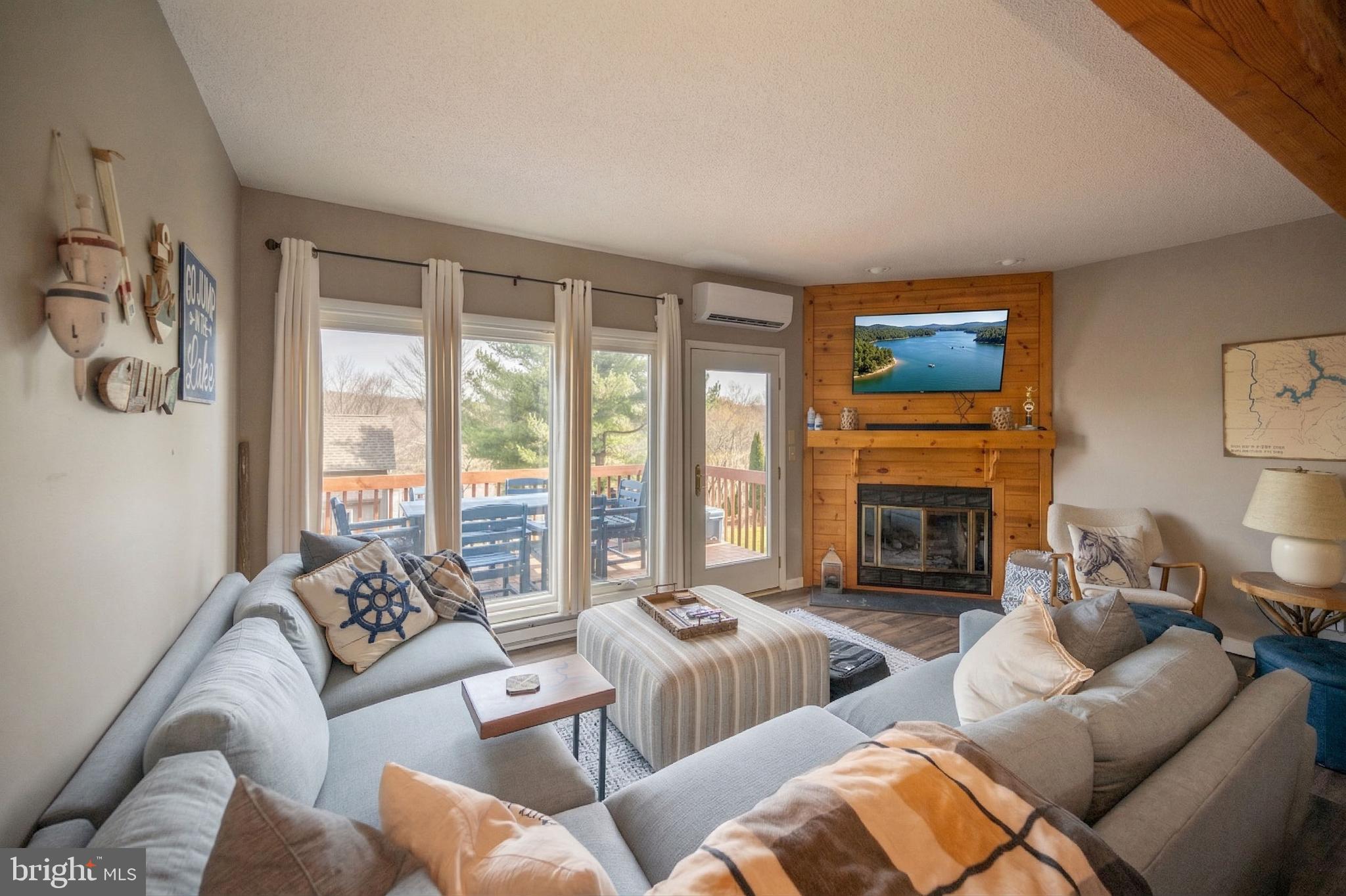257 Marsh Hill Road, Unit 27 McHenry, MD 21541 - Photo 11 of 64 a living room with furniture large window and a fireplace