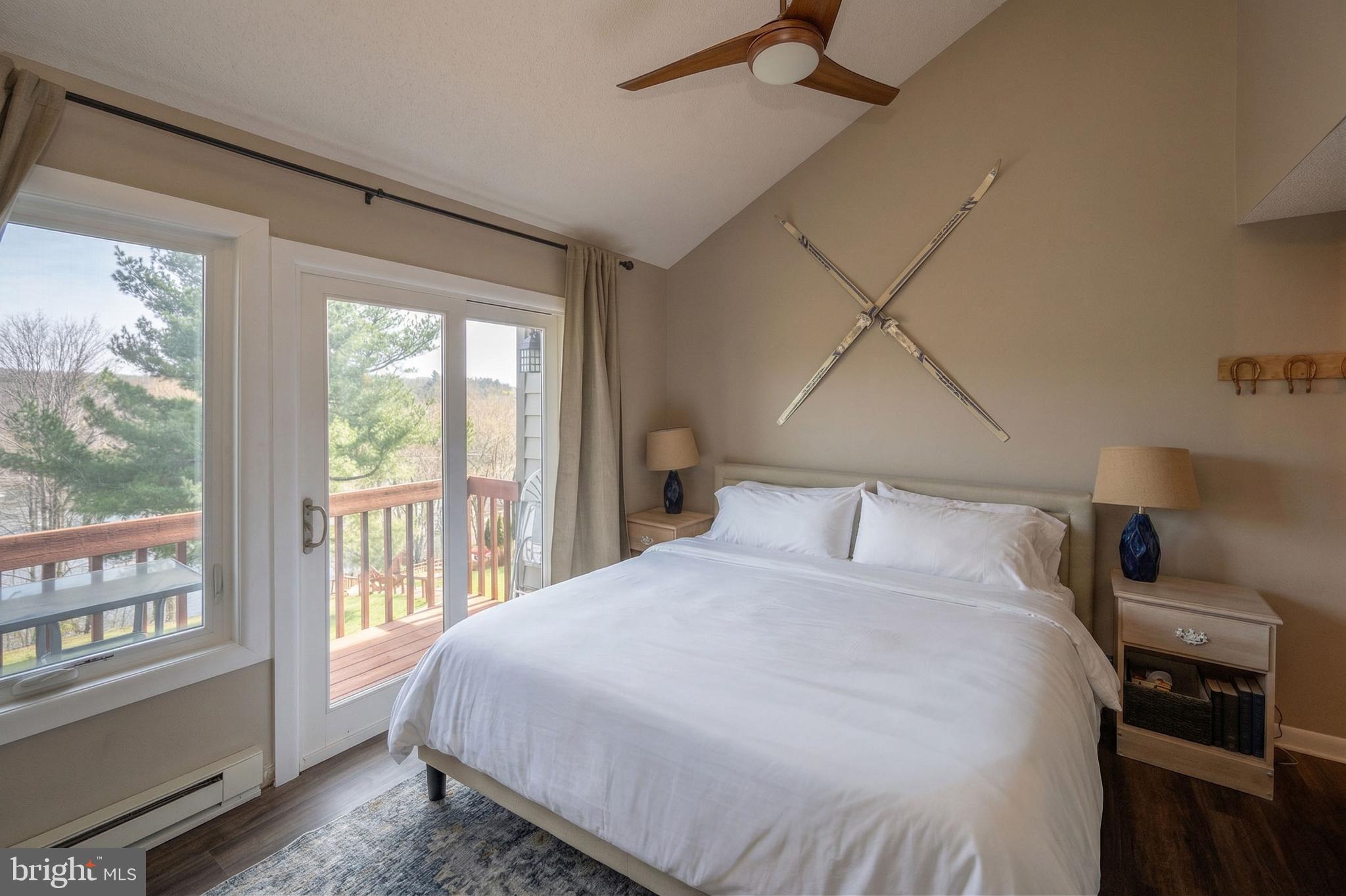 257 Marsh Hill Road, Unit 27 McHenry, MD 21541 - Photo 24 of 64 a bedroom with a large bed and a window