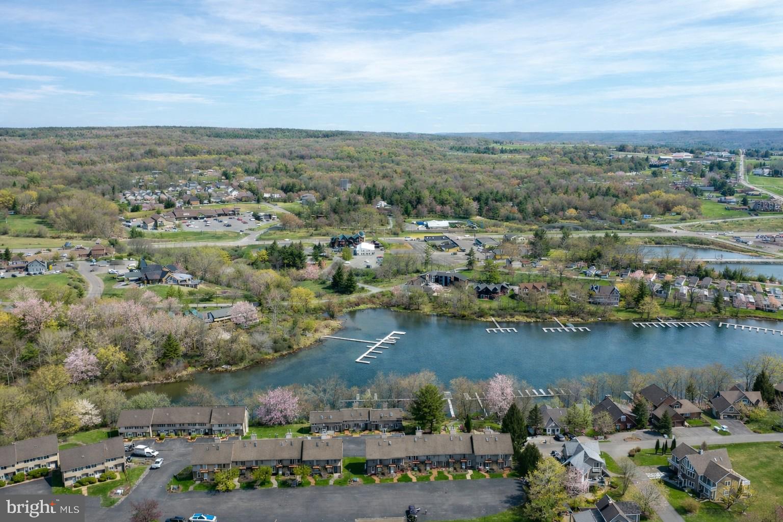 257 Marsh Hill Road, Unit 27 McHenry, MD 21541 - Photo 33 of 64 an aerial view of a city with lots of residential buildings and lake view in back