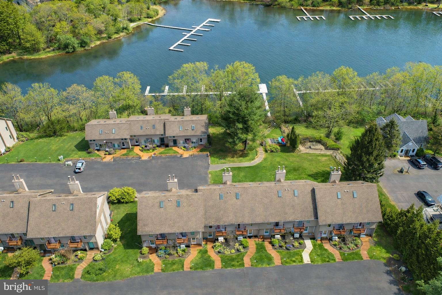 257 Marsh Hill Road, Unit 27 McHenry, MD 21541 - Photo 34 of 64 an aerial view of a house with a garden and lake view