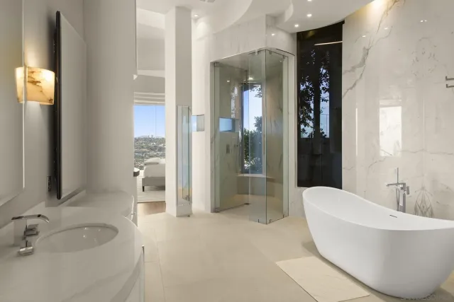 a spacious bathroom with a bathtub and sink