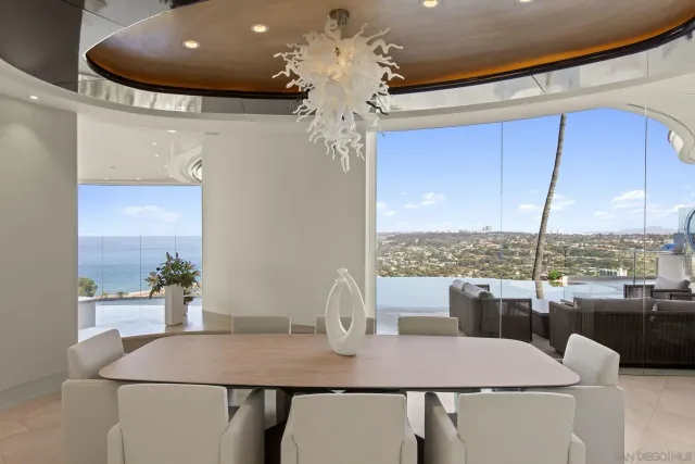 a dining room with furniture and a chandelier