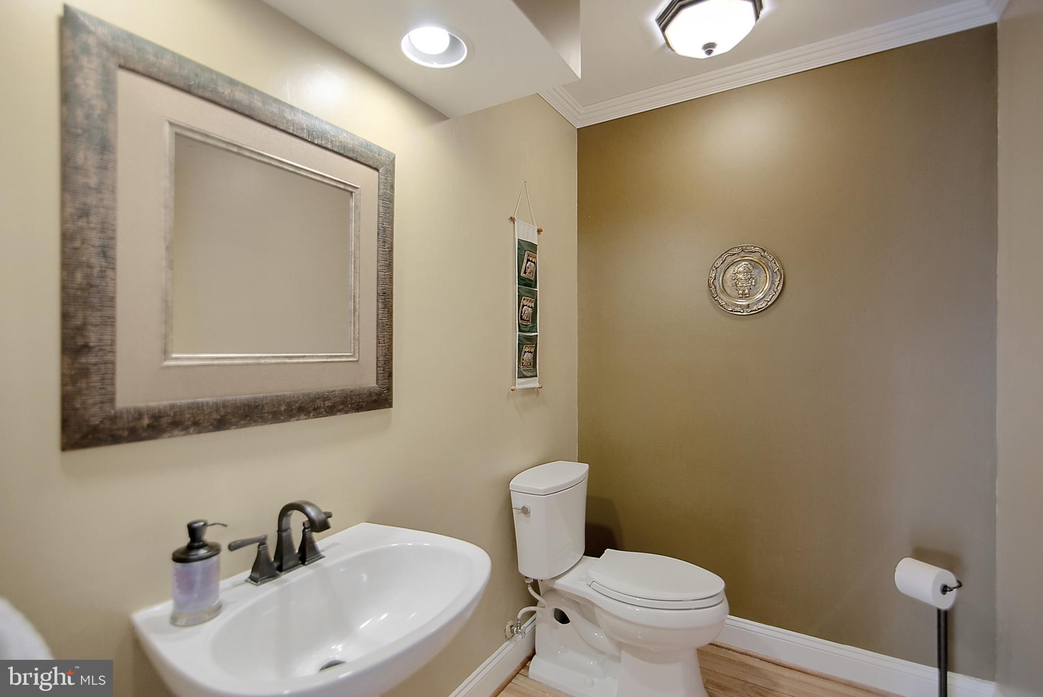 6400 Empty Song Road Columbia, MD 21044 - Photo 24 of 42 Powder room w/hardwood floors and pedestal sink