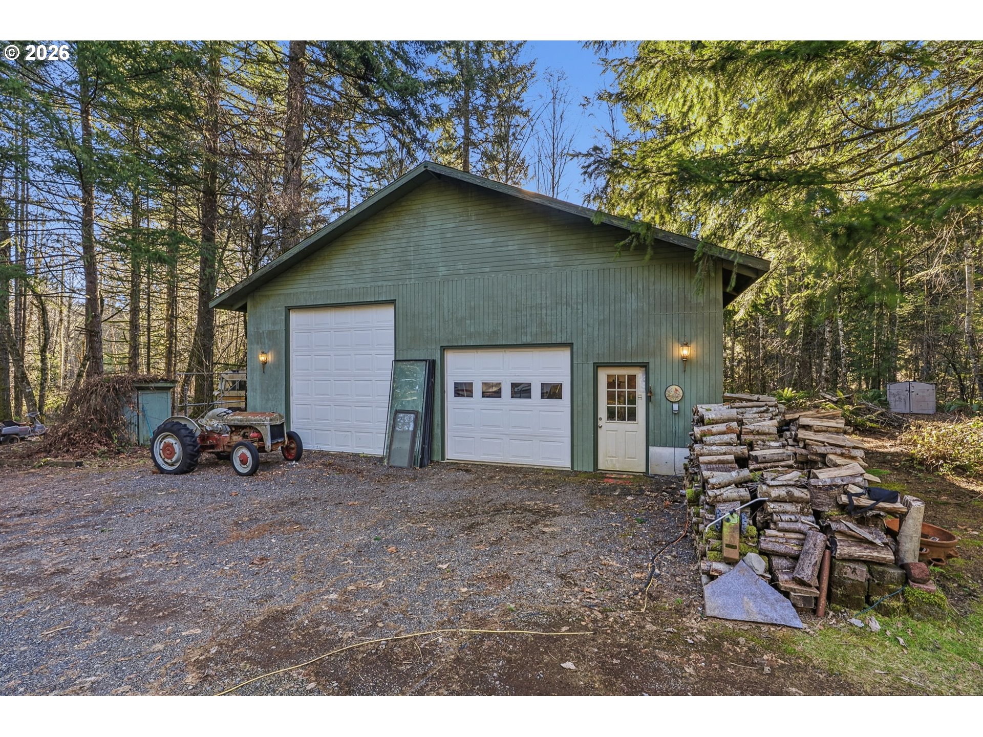 282 Panda Road Washougal, WA 98671 - Photo 16 of 18 a view of a house with large trees and a car parked beside it