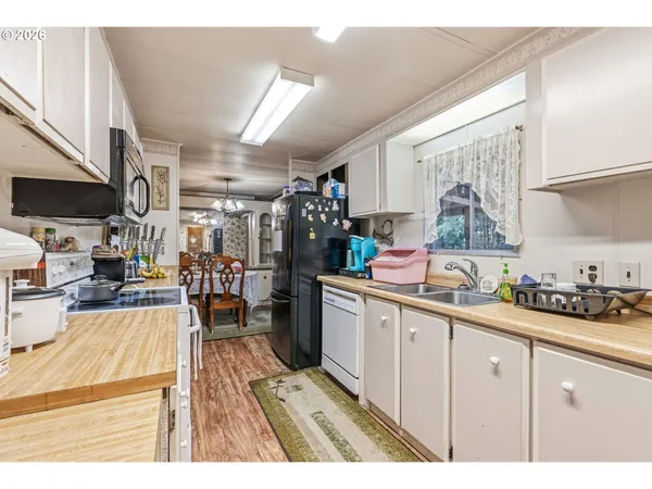 a kitchen with a sink a stove and cabinets