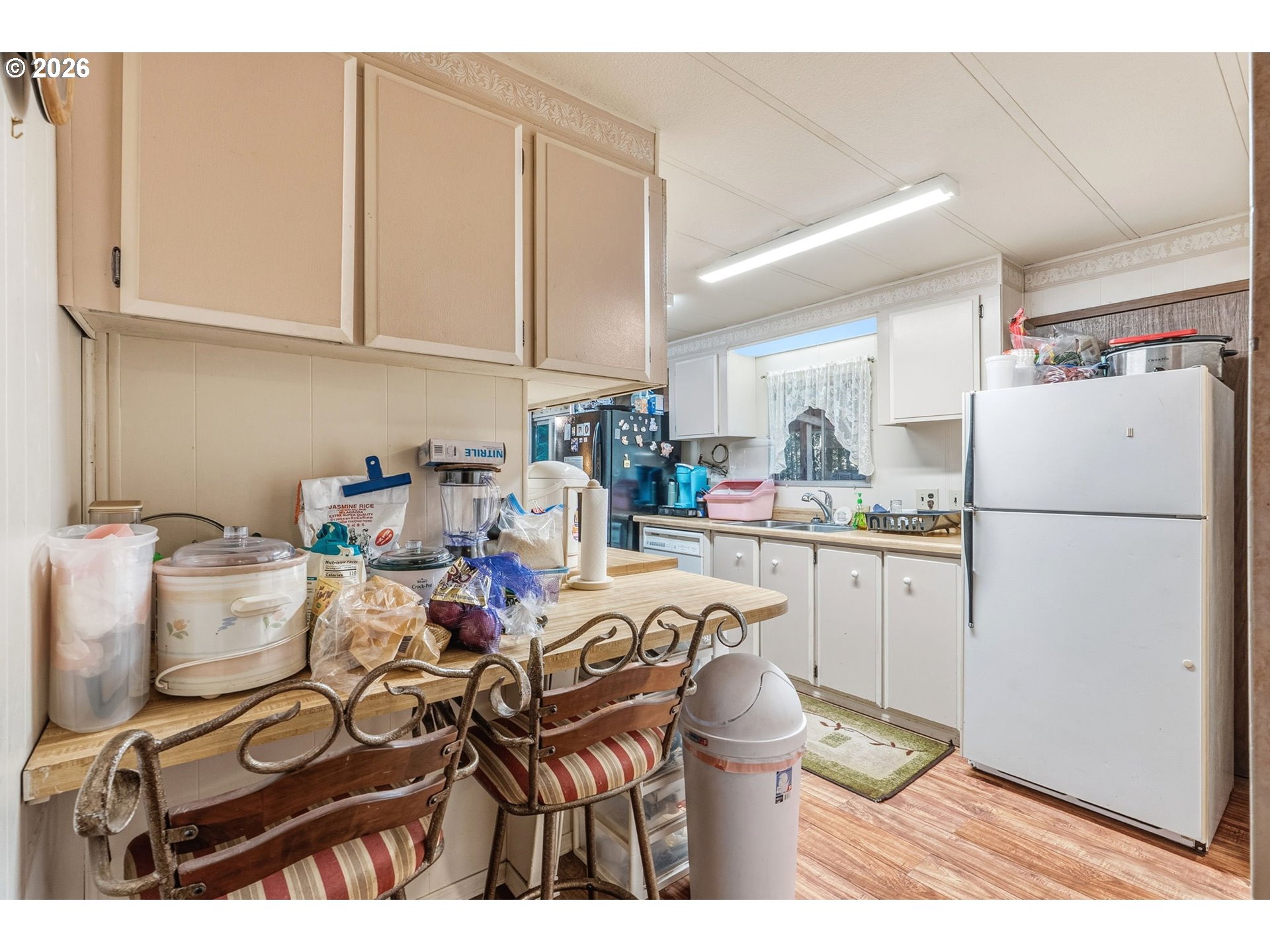 282 Panda Road Washougal, WA 98671 - Photo 9 of 18 a kitchen with a refrigerator and white cabinets
