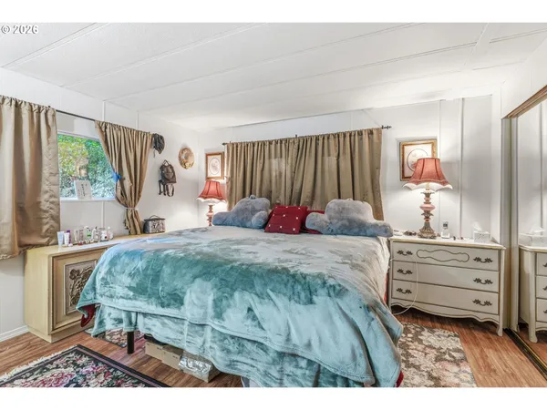 a bed sitting in a bedroom next to a window