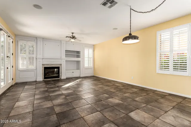 a kitchen with stainless steel appliances kitchen island granite countertop a refrigerator and a stove top oven