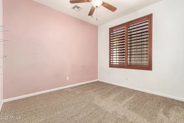 an empty room with painting on the wall