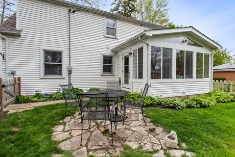 a view of a house with a yard and sitting area