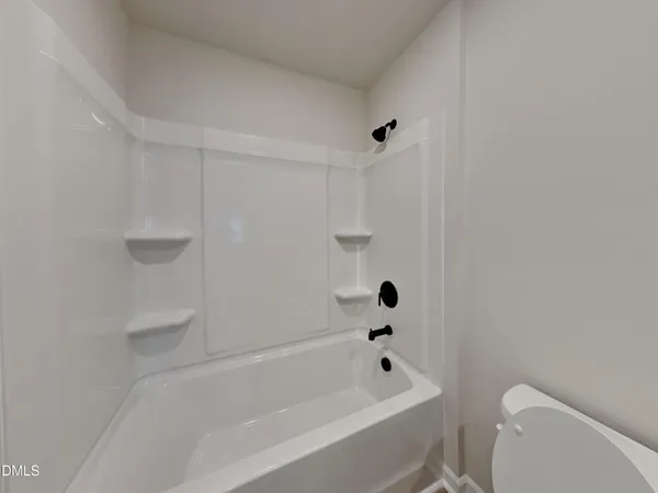 a bathroom with a bathtub and toilet