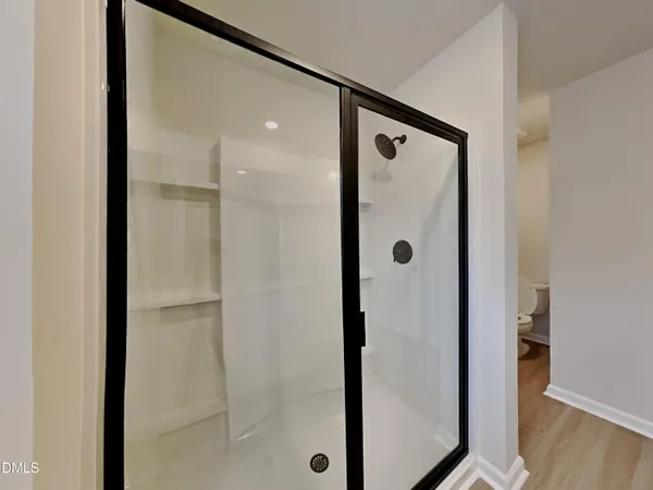 a bathroom with a glass shower door