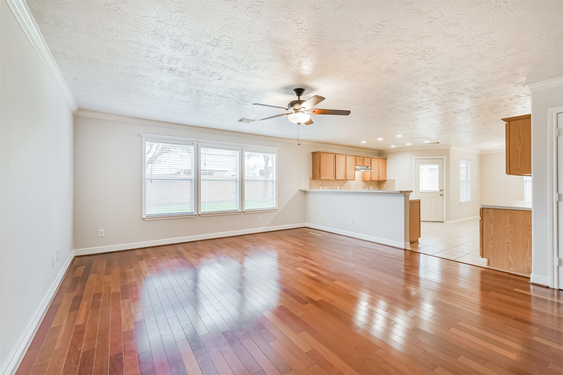 15023 Roche Rock Drive Humble, TX 77396 - Photo 5 of 40 a view of an empty room with window and wooden floor