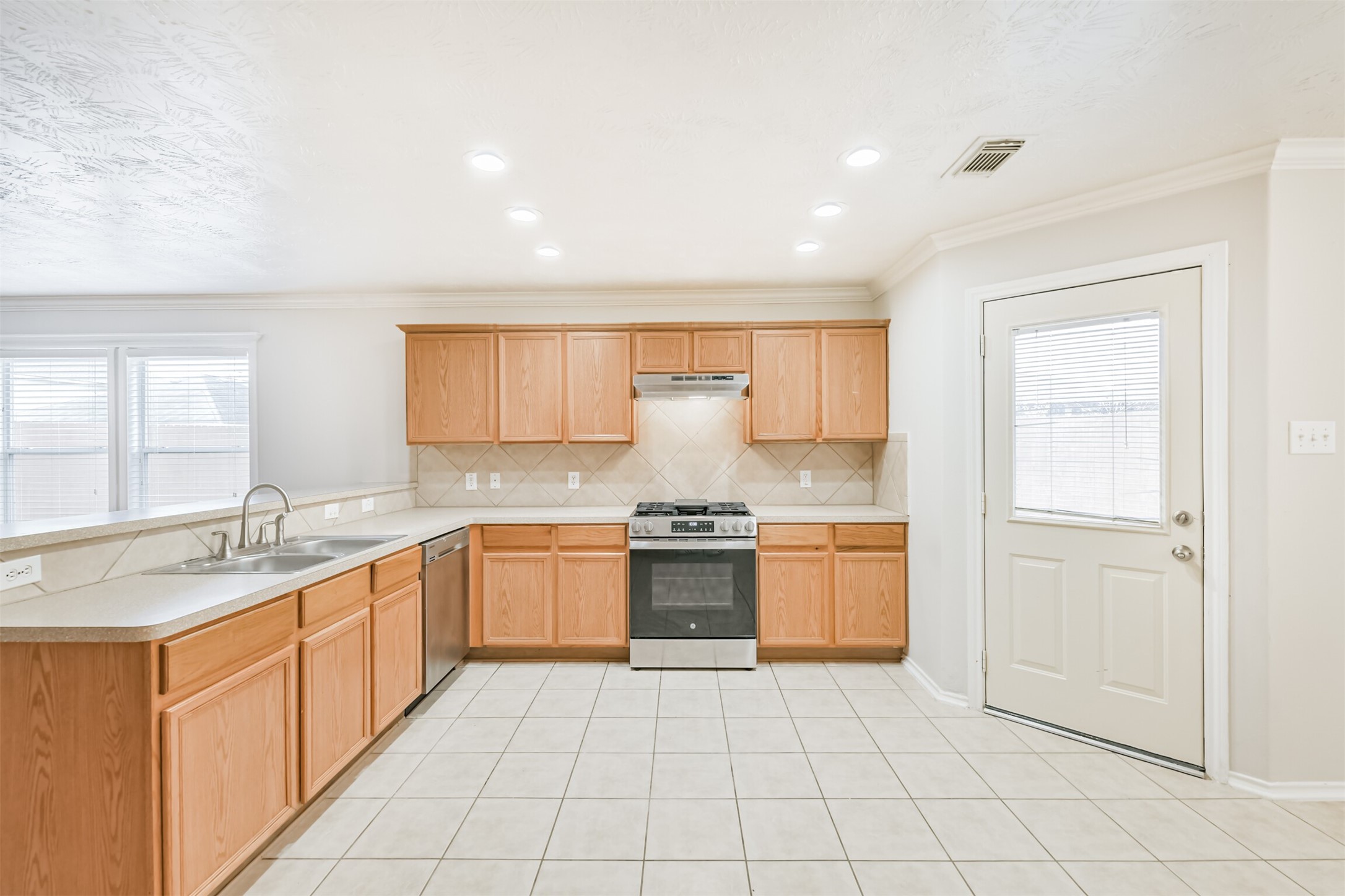 15023 Roche Rock Drive Humble, TX 77396 - Photo 10 of 40 a kitchen with a sink stove and cabinets