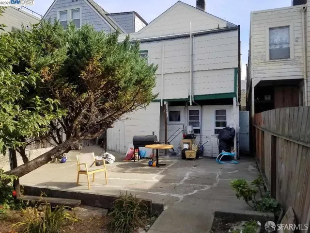 a view of a patio with furniture and a fire pit