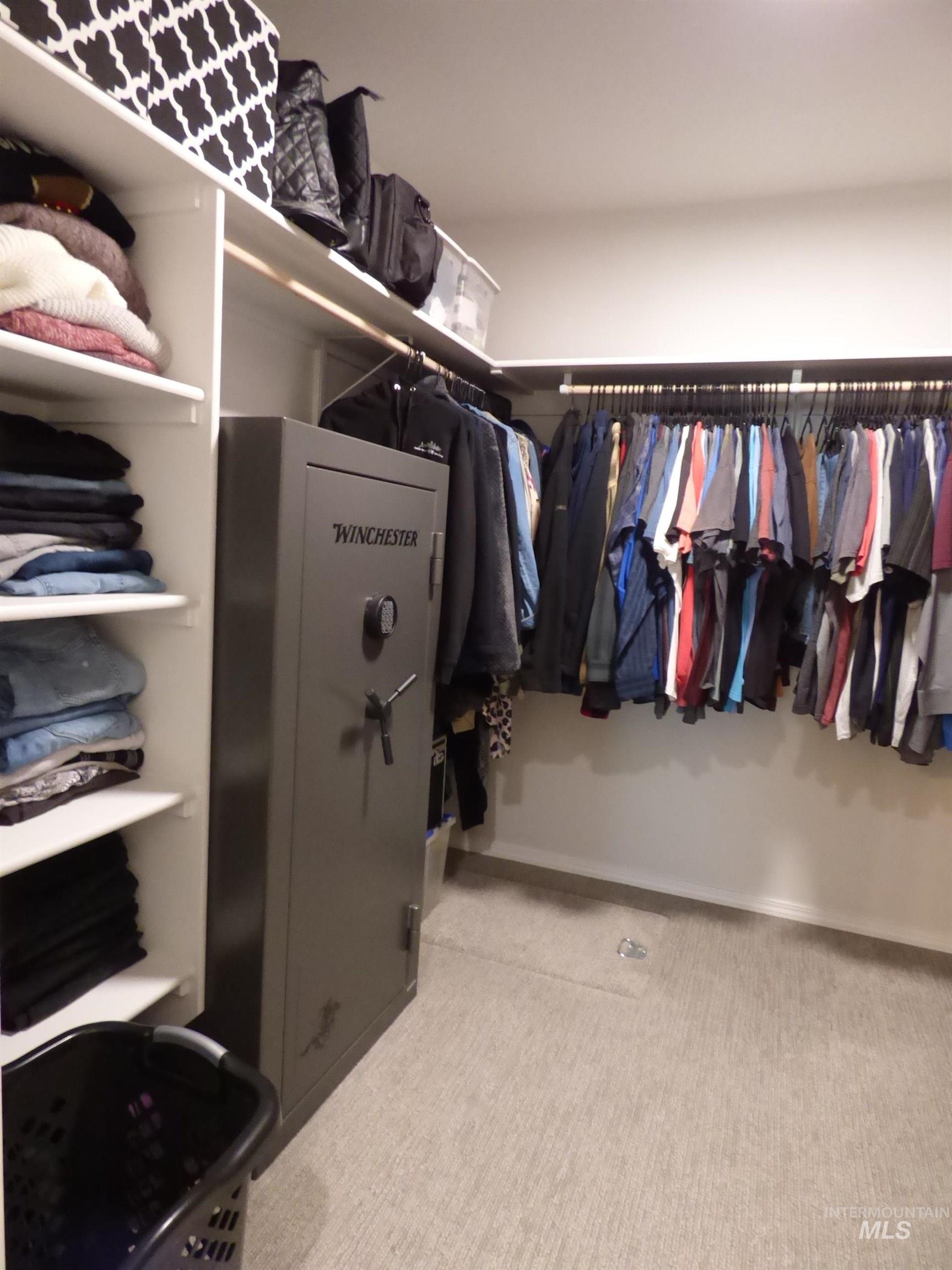 2708 East Buckaroo Drive Kuna, ID 83634 - Photo 23 of 48 Spacious walk-in closet featuring light-toned carpeting, white shelving, and dual clothes hanging rods