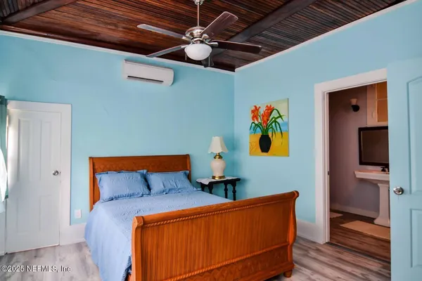 a blue bed sitting in a bedroom next to a window