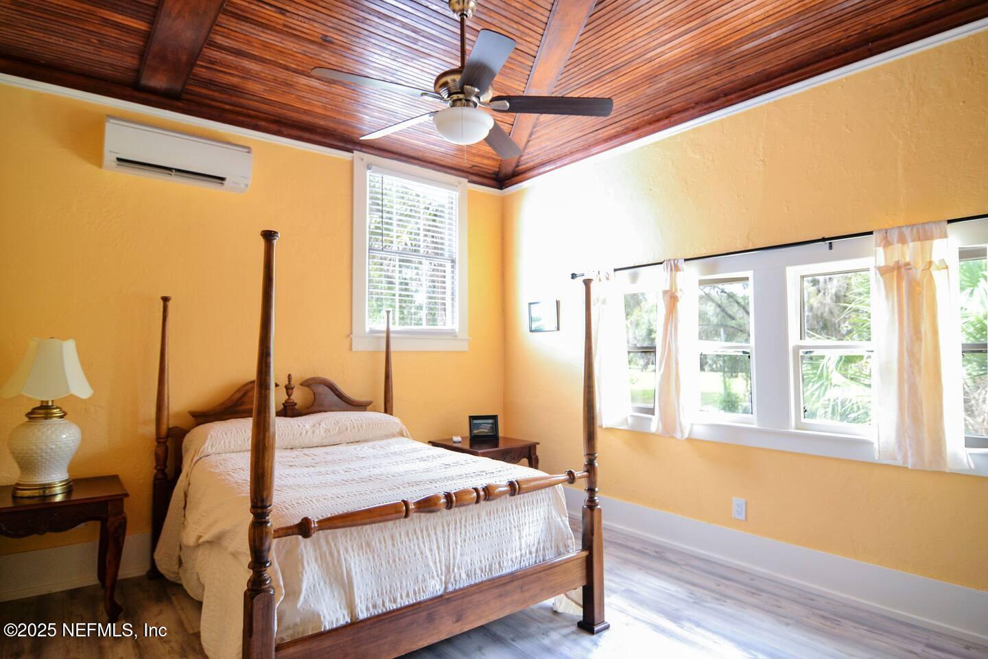 103 Beacon Street Interlachen, FL 32148 - Photo 13 of 31 a bedroom with a bed and wooden floor