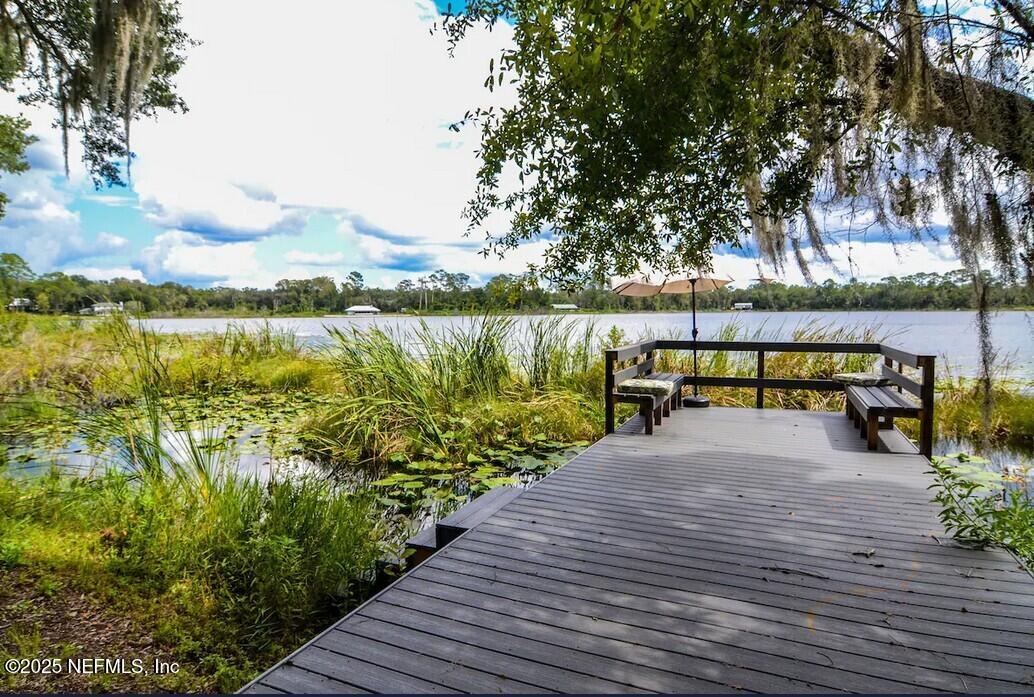 103 Beacon Street Interlachen, FL 32148 - Photo 2 of 31 a park with large trees and houses with wooden fence