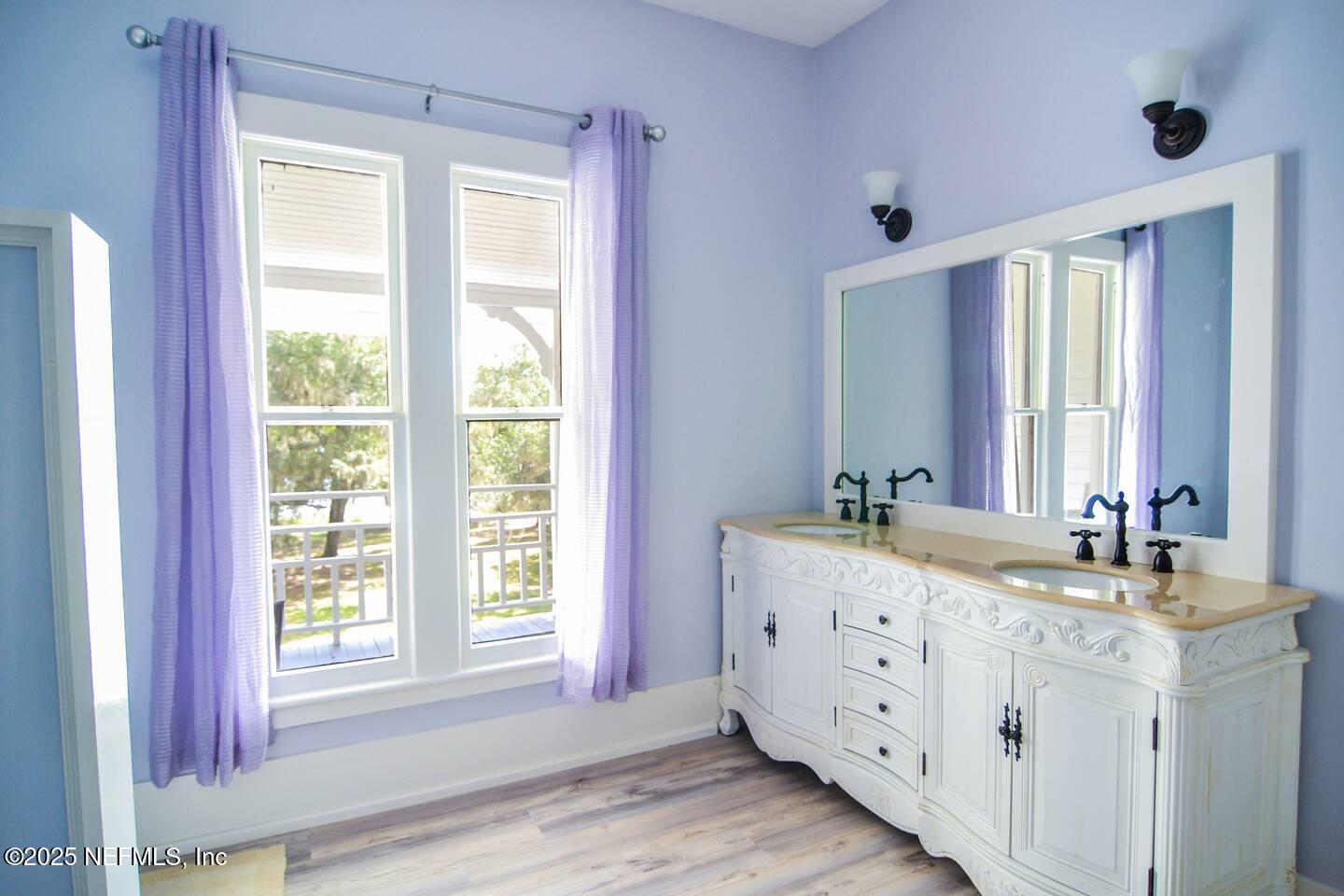 103 Beacon Street Interlachen, FL 32148 - Photo 6 of 31 a bathroom with a double vanity sink window and mirror