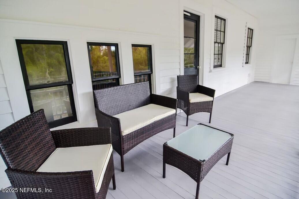103 Beacon Street Interlachen, FL 32148 - Photo 7 of 31 a living room with furniture and wooden floor