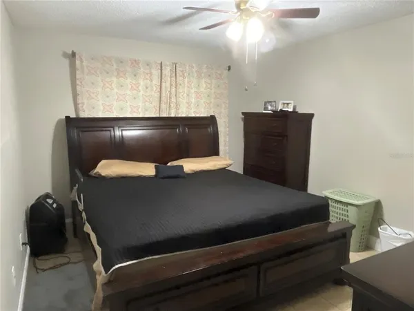 a bed sitting in a bedroom next to a window