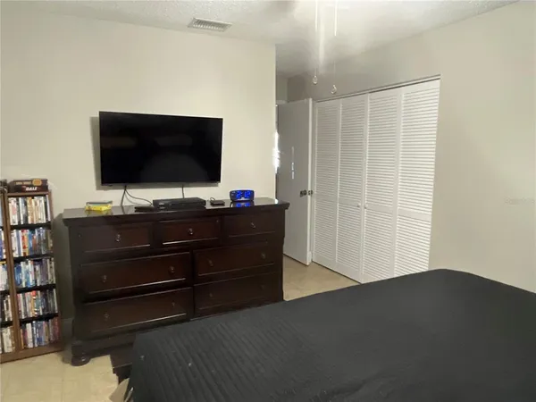 a room with a flat screen tv and a window