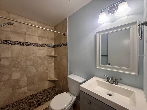 a bathroom with a sink toilet and shower