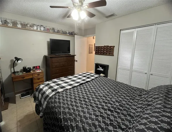 a bedroom with a bed and a television