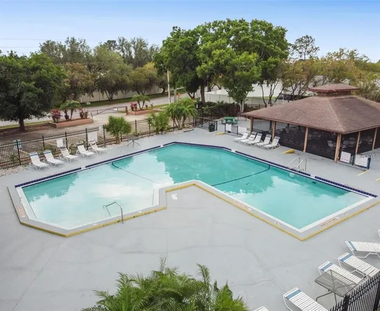 an aerial view of a house with a garden and a swimming pool