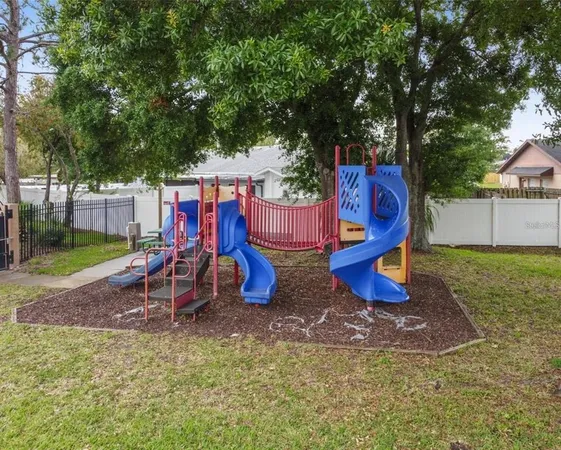 a view of outdoor space with playground and green space
