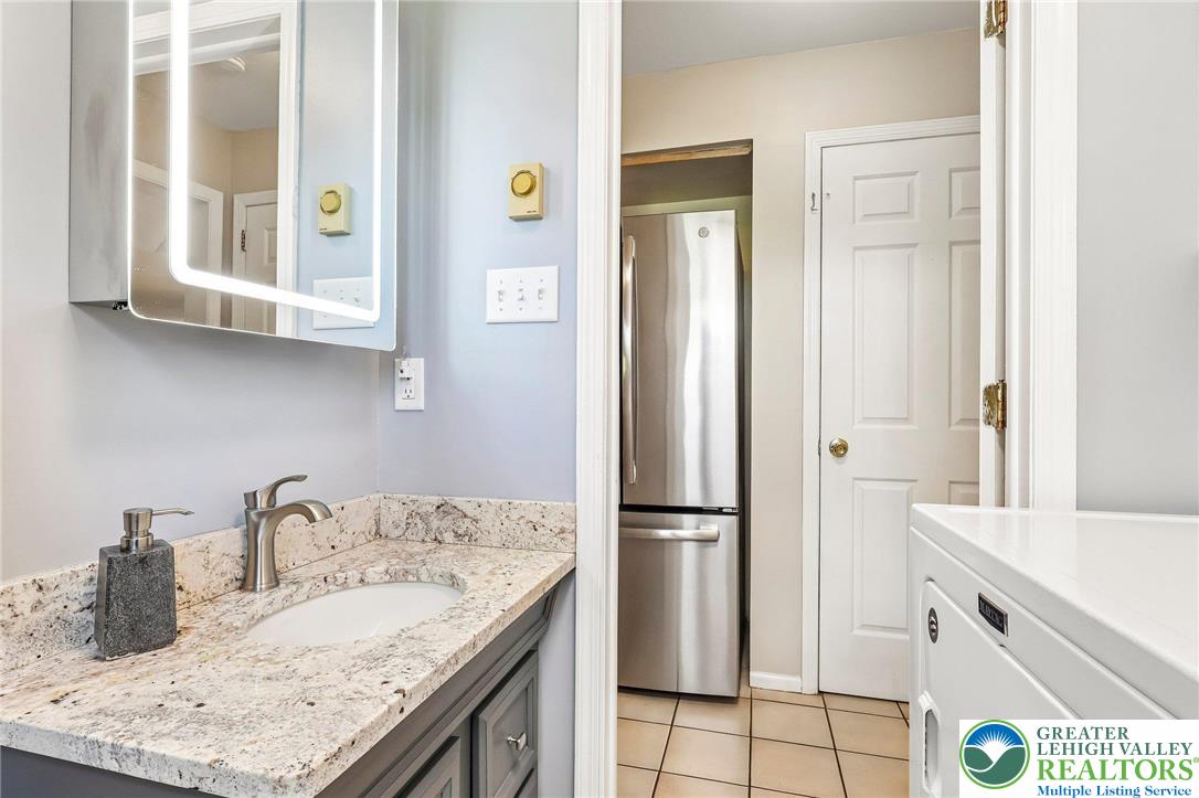 574 Carol Lane Bath, PA 18014 - Photo 17 of 46 a kitchen with a sink and a refrigerator