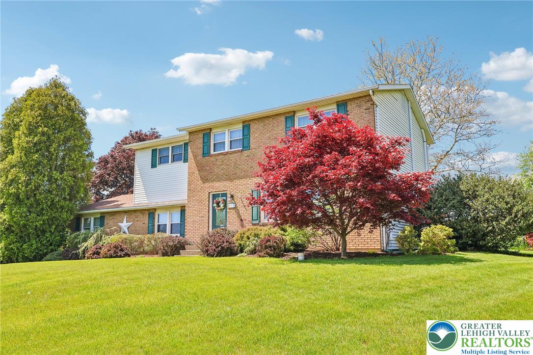 574 Carol Lane Bath, PA 18014 - Photo 2 of 46 a front view of a house with a big yard and a large tree