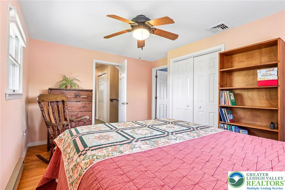 574 Carol Lane Bath, PA 18014 - Photo 24 of 46 a bedroom with a bed and a chandelier