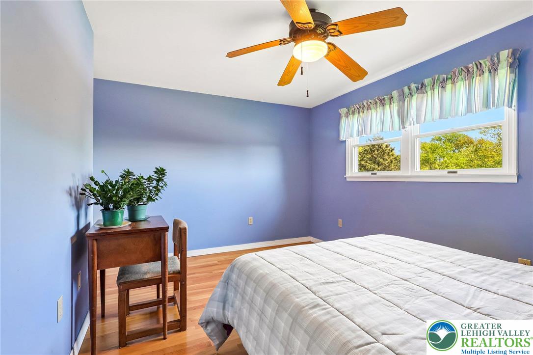 574 Carol Lane Bath, PA 18014 - Photo 26 of 46 a bedroom with a bed and a chandelier