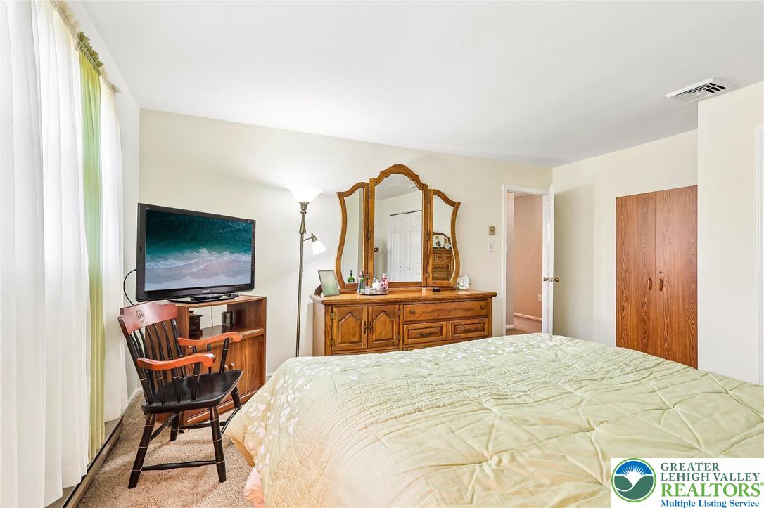 574 Carol Lane Bath, PA 18014 - Photo 34 of 46 a bedroom with a bed and a flat screen tv
