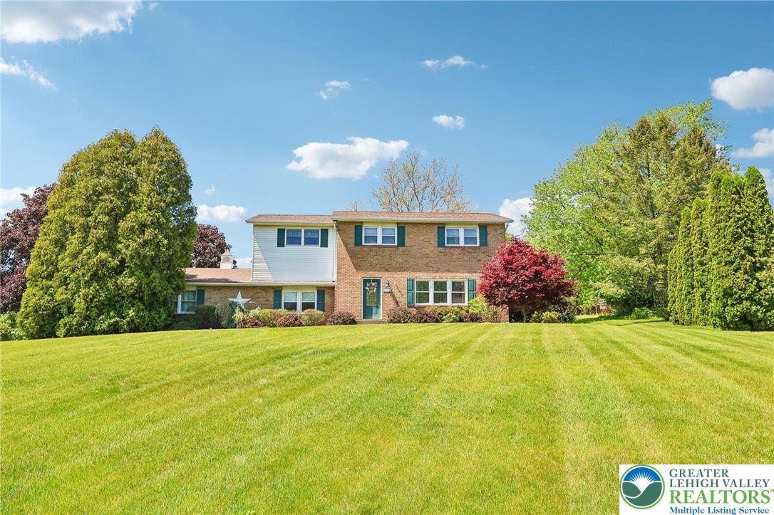 574 Carol Lane Bath, PA 18014 - Photo 6 of 46 a view of a house with a yard and a garage