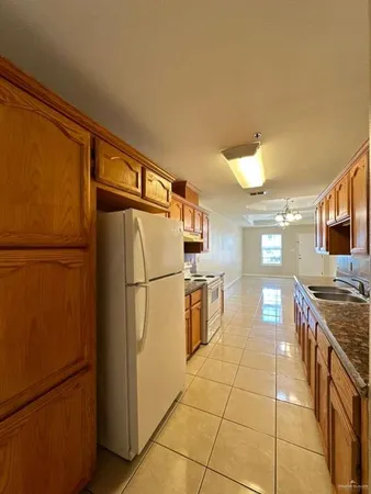 a kitchen with stainless steel appliances granite countertop a refrigerator and a stove