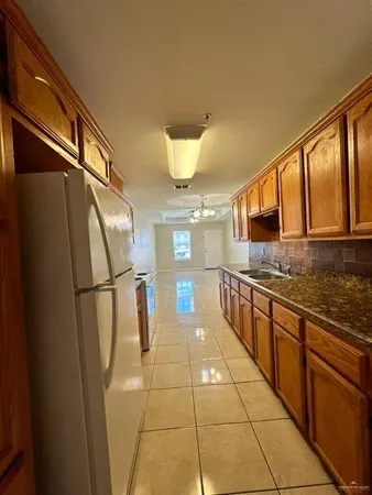 a large white kitchen with a large window