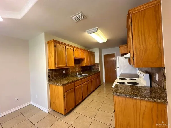 a kitchen with stainless steel appliances granite countertop a stove and a refrigerator