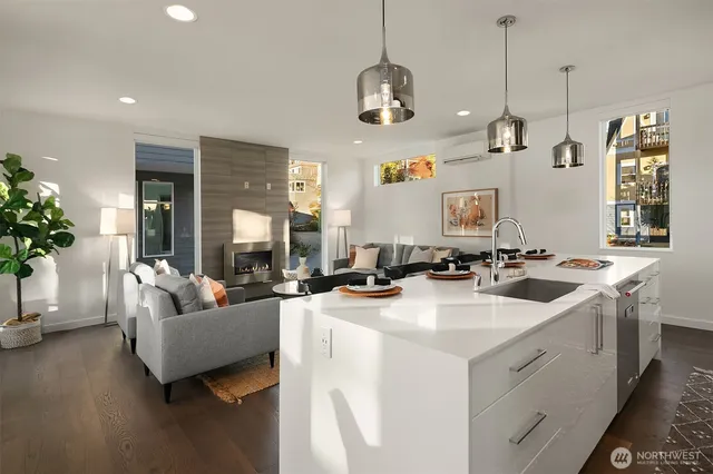 a view of living room and kitchen with a stove a sink and dishwasher